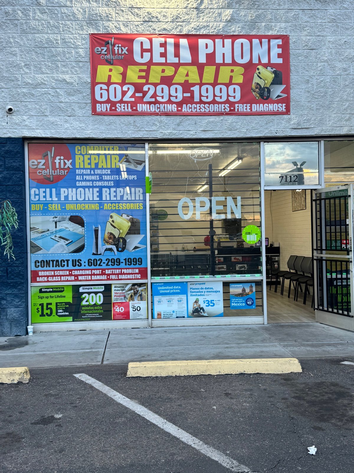 Ez Fix cell phone repair storefront with red and white signage, phone number 602-299-1999, displaying open sign in window